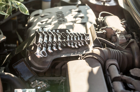 Closeup shot of set of tools lying on car engineの写真素材