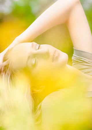 Closeup shot of beautiful blonde woman at parkの写真素材