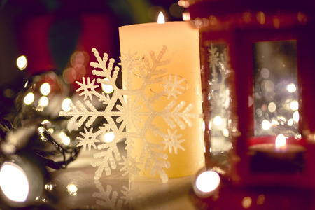 Closeup photo of burning candle on decorated Christmas tableの写真素材