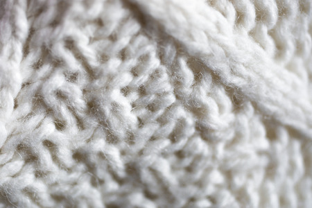 Closeup texture of white knitted woolen sweater