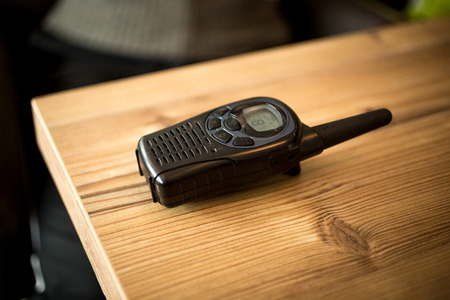 Closeup photo of walkie-talkie lying on wooden table