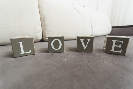 Macro photo of word Love spelled by letters on wooden bricksの写真素材