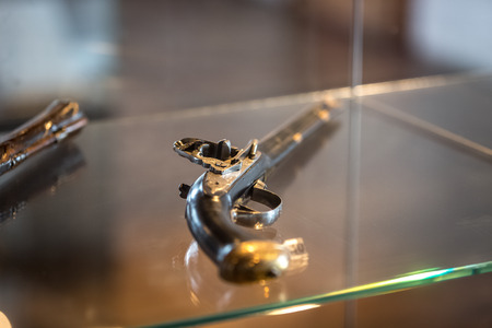 Closeup photo of old pistol with wooden handleの写真素材