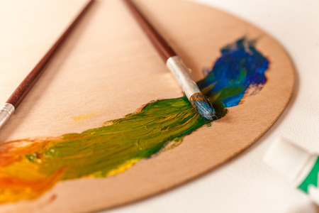 Closeup photo of green to blue gradient made by oil paints on palletの写真素材