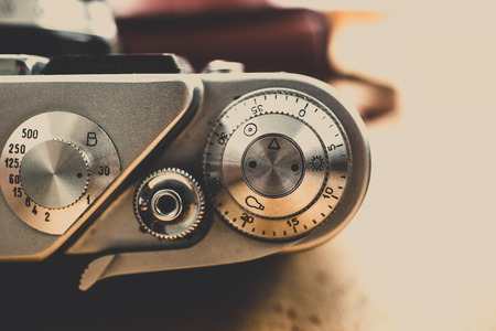 Macro toned shot of metal buttons and controls on vintage film camera