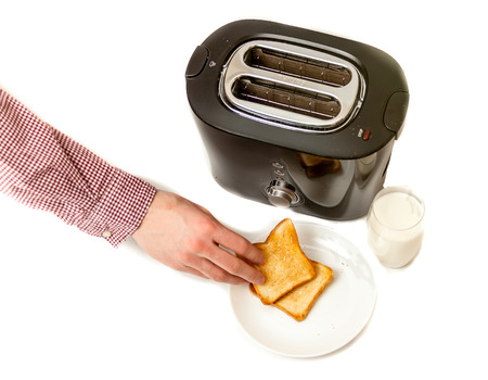 Closeup isolated shot of man putting baked toasts on white dish