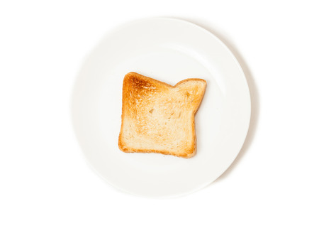 Closeup isolated shot of fresh baked toast on white dishの写真素材