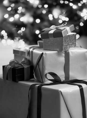 Closeup black and white photo of Christmas gift boxes lying on floor at living roomの写真素材