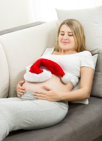 Concept of young pregnant woman waiting for Christmasの写真素材