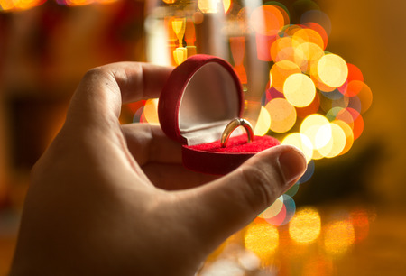 Closeup photo of man making proposal at Christmas eveの写真素材