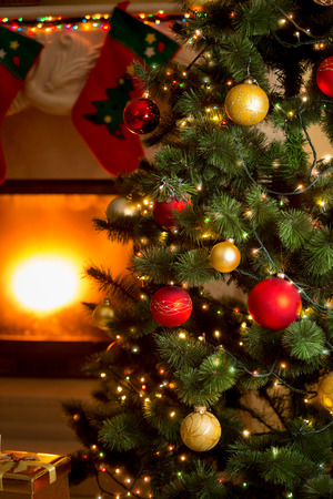 Beautiful background of decorated Christmas tree and fireplaceの写真素材