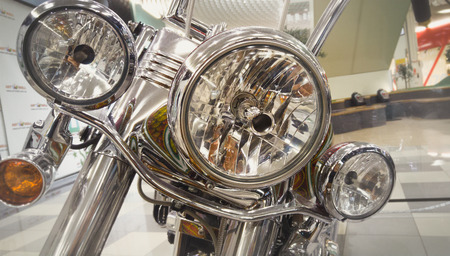 Closeup toned photo of chromed headlamp of chopper motorcycle
