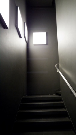 Dark stairs in modern building illuminated by light panelsの写真素材