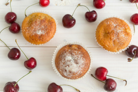 View from above on muffins decorated with fresh cherriesの写真素材