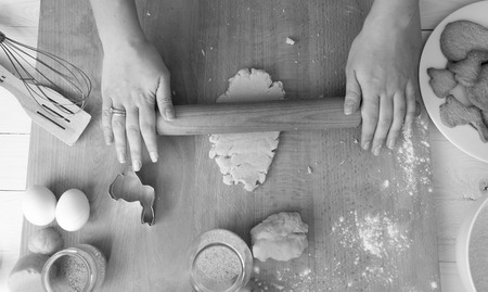 Black and white image from above on woman preparing dough for holiday cookiesの写真素材
