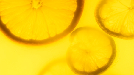 Closeup image of silhouettes of freshly cut otanges and lemons