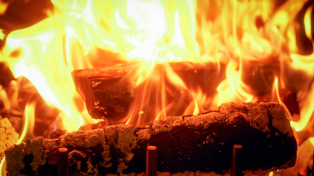 Closeup photo of wooden logs burning in fireplace