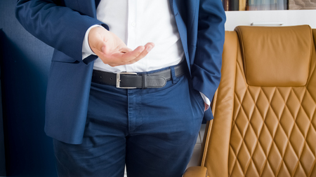 Closeup photo of businessman standing at office and tossing coinの写真素材