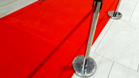 Closeup photo of red carpet road and barriers on the opening of celebrity gala award showの写真素材