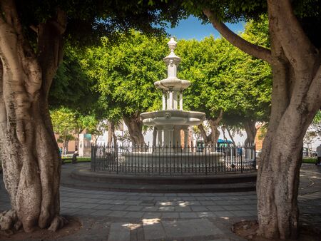 Beautiful image of stone fountain on square at parkの写真素材