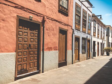 Toned photo of old wooden doors on narrow street of spanish town San Cristobal de La Laguna, Tenerifeの写真素材