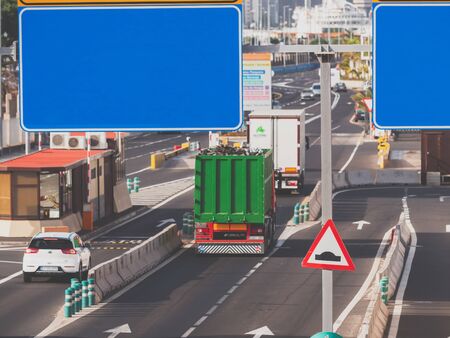 Toned photo of heavy cargo trucks and cars riding on busy highway at sunset. Place for your text....