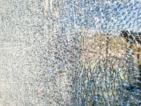 Closeup texture of shattered mirror or glass in lots of small piecesの写真素材