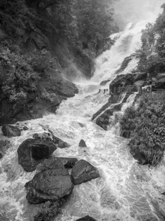 Black and white photo of water stream got overflood after heavy tropical rain in mountains