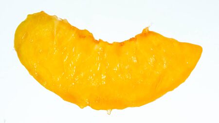 Isolated closeup image of juice peach slice over white background. Abstract background of berries...