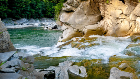 Fast water stream on the waterfall cascade in mountains flowing in lake