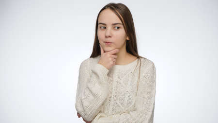 Studio shot of thoughtful teenage girl thinking over white background