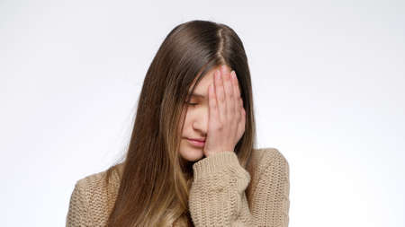 Portrait of displeased girl making facepalm gesture and hitting face with hand