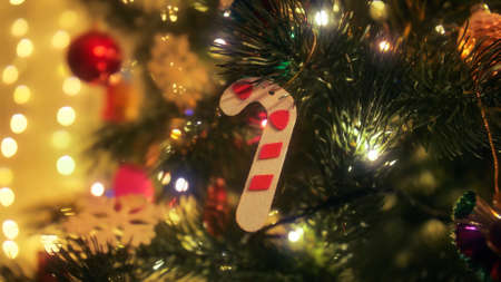 Christmas tree decorations and baubles. Decorative candy candle hanging on Christmas tree