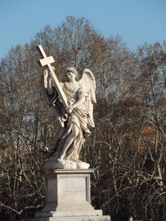 Statue of an angel with a cross in Romeの写真素材