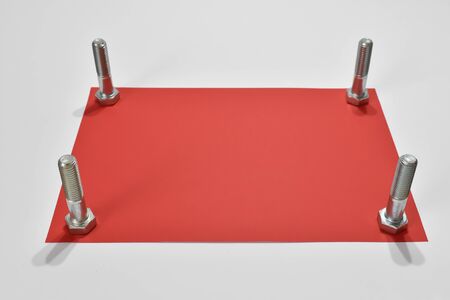 Red card and steel screws.の写真素材