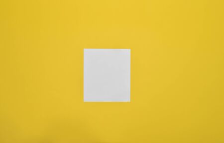 White sheet of paper on a yellow background.の写真素材