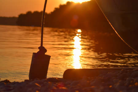 Metal tin on a rope by the lake.の写真素材