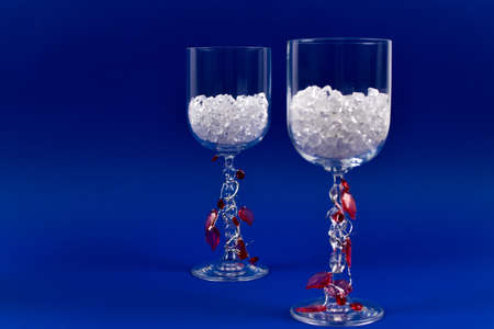 Tall glasses and red crystals.の写真素材
