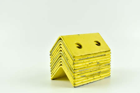 Metal, yellow square on a light background.