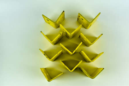 Metal, yellow square on a light background.