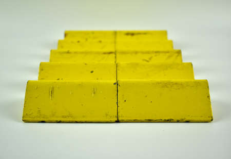 Metal, yellow square on a light background.