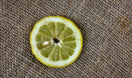 Sliced lemon on a sackcloth background. Close-up.の写真素材
