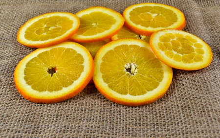 Slices of orange on a burlap background. Close-up.の写真素材