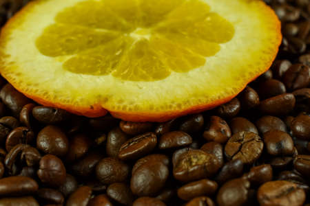 Coffee beans and a slice of orange on a dark backgroundの写真素材