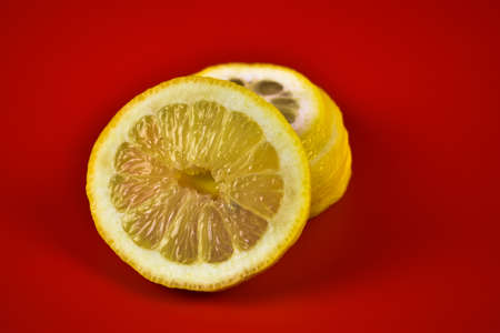 Sliced lemon on a red background. Close-up.の写真素材