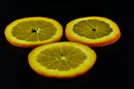 Slices of orange on a black background, close-upの写真素材