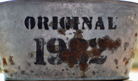 Rusty metal plate with the inscription of the word ORIGINAL 1932 on itの写真素材