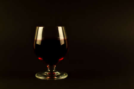 A glass of red wine on a dark background. High quality photoの写真素材