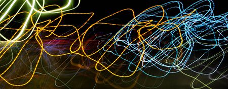 Black background with multicolored luminous linesの写真素材