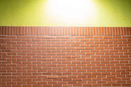 Brick wall and yellow wall texture.の写真素材